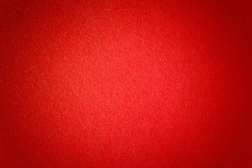 Red felt background with vignette. Soft natural wool material, surface of a casino poker table,...