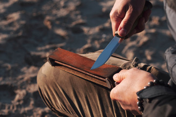 Man hands sharpening a knife.Sharpening a bushcraft knife.
