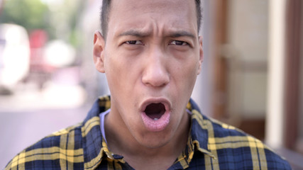 The Close up of Wondering Young African Man in Shock, Outdoor