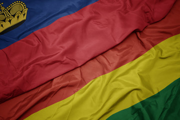 waving colorful flag of bolivia and national flag of liechtenstein.