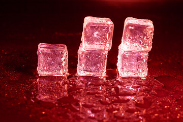 ice cubes on a reflections red light.