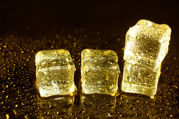 ice cubes on a reflections yellow light.