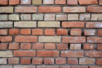Old repaired weathered brick wall for background. 