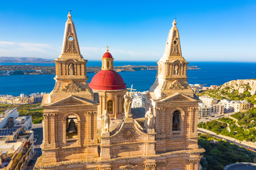 Aerial view close up view of Mellieha Parish Church or Birth of Our Lady. Sea and blue sky. Malta 
