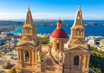 Aerial view close up view of Mellieha Parish Church or Birth of Our Lady. Sea and blue sky. Malta...