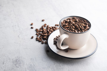 Cup filled with roasted coffee beans