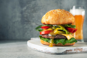 Huge and Juicy green burger with mustard honey sauce and beer glass