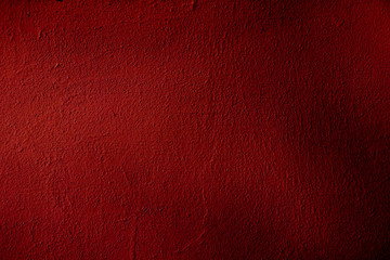 Fototapeta premium A grungy background is slightly dark red with blackout. Dark red color uneven surface for design and text.