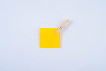 Orange note with wooden clip isolated