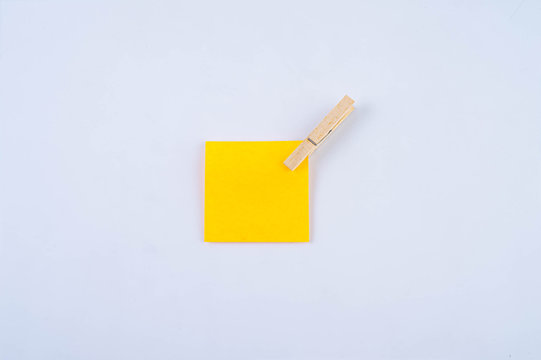 Orange note with wooden clip isolated
