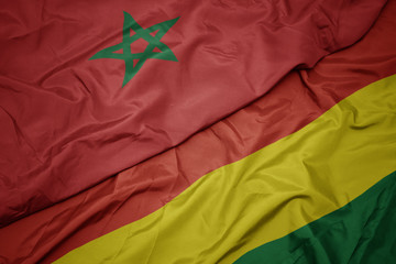 waving colorful flag of bolivia and national flag of morocco.