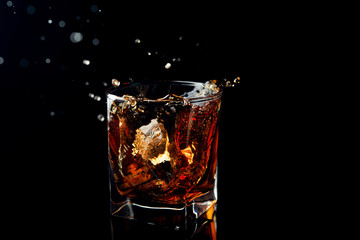Whiskey splash in glass