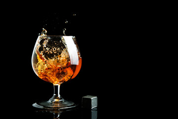 Whiskey splash in glass