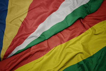 waving colorful flag of bolivia and national flag of seychelles.