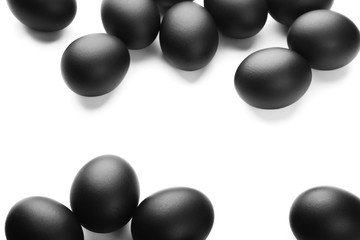 Composition of black easter eggs on a white background. Easter minimalistic concept