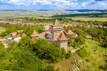 Fototapeta na wymiar Viscri village church and cemetery in the traditional saxon village Viscri near Brasov, Romania