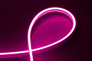 Flexible purple LED neon strip on black background