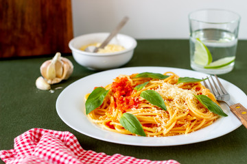 Pasta spaghetti with tomatoes, basil and parmesan cheese. Italian cuisine. Recipe. Vegetarian food. Healthy eating.