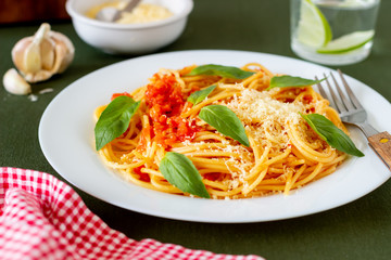 Pasta spaghetti with tomatoes, basil and parmesan cheese. Italian cuisine. Recipe. Vegetarian food. Healthy eating.