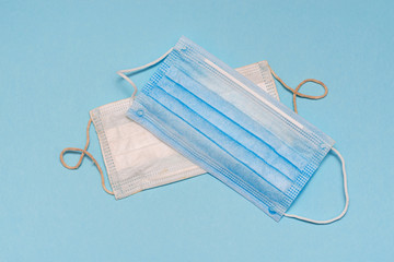 Two medical protective masks on a blue background