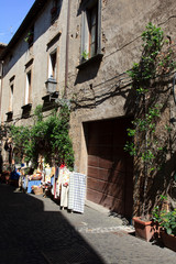 Fototapeta na wymiar Orvieto (TR), Italy - May 10, 2016: A typical road and houses in centre of Orvieto, Terni, Umbria, Italy