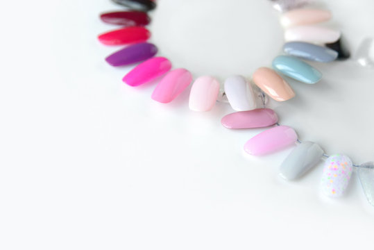 Nail polish samples in different bright colors. Colorful nail lacquer manicure swatches. Top view of nail art wheel palette.