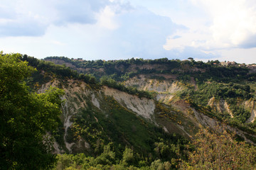 Fototapeta na wymiar Civita di Bagnoregio (VT), Italy - May 15, 2016: Soft eroded clay landscape around Civita di Bagnoregio, Tuscia, Lazio, Italy