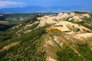Fototapeta na wymiar Civita di Bagnoregio (VT), Italy - May 15, 2016: Soft eroded clay landscape around Civita di Bagnoregio, Tuscia, Lazio, Italy