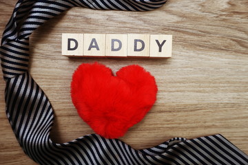 Happy Father's Day concept with DADDY alphabet letter with space copy on wooden background