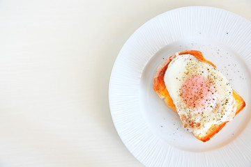 Egg cheese toast on a white plate with copy space