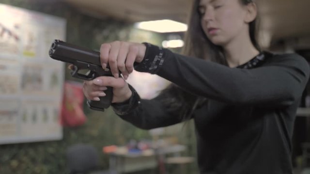 Girl pulls out a gun charges and aims