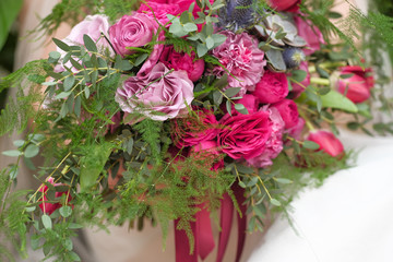 Beautiful bright wedding bouquet close-up. wedding purple boho bouquet in bride's hands