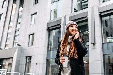 Young woman in outerwear speaks on the phone