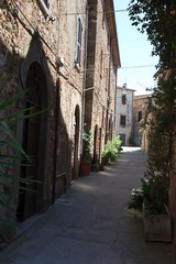 Fototapeta premium Montemerano (GR), Italy - September 11, 2017: A typical road and houses in Montemerano village, Manciano, Grosseto, Tuscany, Italy, Europe