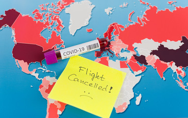 Note flight canceled and positive covid-19 blood test . Coronavirus spresd concept. Flight restricted concept and canceled note on world map.