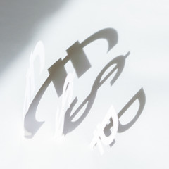 Badges of the currency, cut out of paper. The concept of devaluation of the ruble.