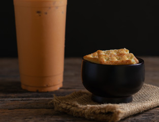 Biscuits with ice milk tea on wooden