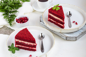 Cake Red velvet on two white plates, two servings. On a light background. Birthday, holidays, sweets.