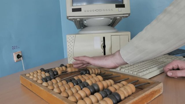 Man Working With Abacus An Ancient Calculator, Retro Computer And Modern Laptop. Concept: Development Of Computing Technology 