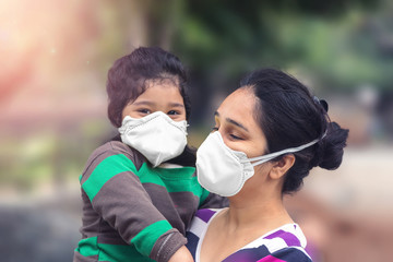 Covid-19 Coronavirus and Air pollution pm2.5 concept.Little Indian baby girl and mother wearing mask for protect and to stop corona virus outbreak 