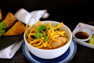Noodle soup with chicken on wood table