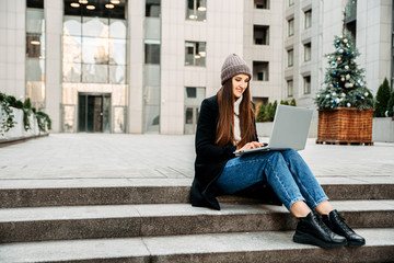 A student girl uses a laptop to study