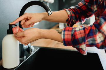 Woman washing hands with soap