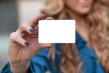 Blonde beautiful woman is holding an empty card in her hand