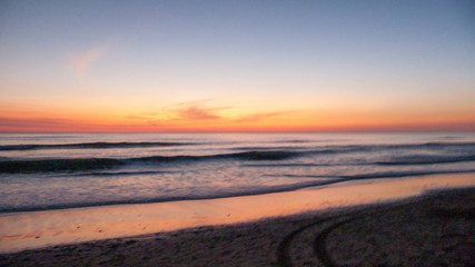Fototapeta na wymiar trails on the sunset beach
