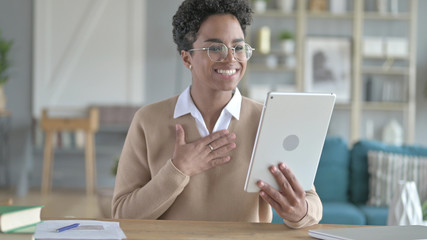 The Cheerful African Girl Doing video Chat on Tablet