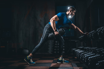 young athlete has physical workout with barbell in modern gym