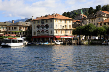 Fototapeta na wymiar Orta San Giulio (NO), Italy - September 02, 2019: The little port in Orta lake, Orta, Novara, Piedmont, Italy