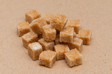 brown refined sugar cubes on craft paper background