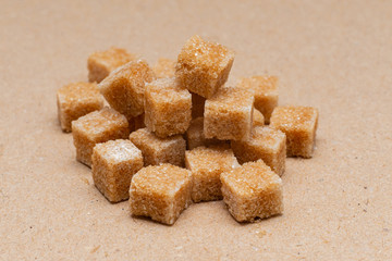 brown refined sugar cubes on craft paper background